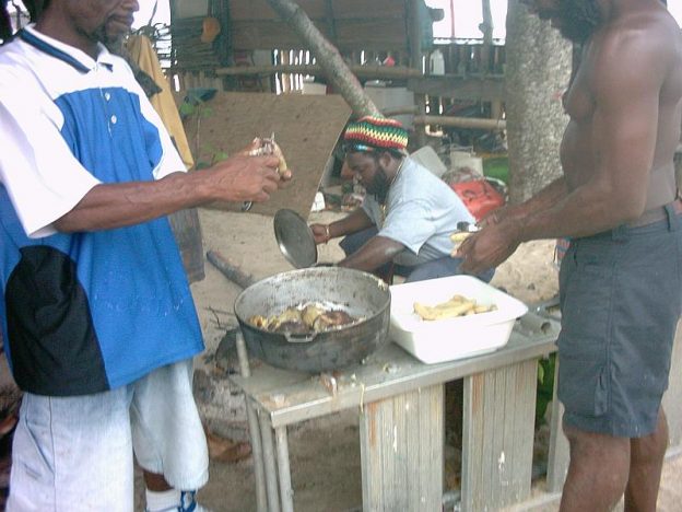 Locals on Carriacou cooking a fish stew.