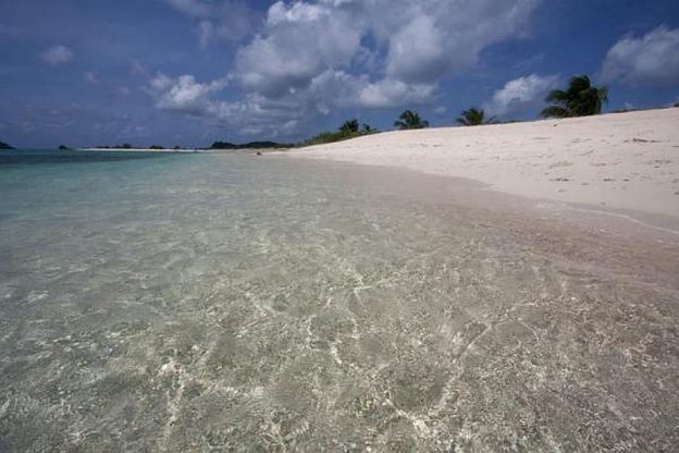 Crystal clear waters at sandy island.