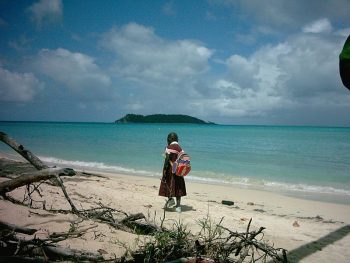 Paradise beach, schoolgirl walking home.